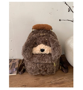 Detail of cute brown plush puppy backpack showing furry texture and zipper pocket