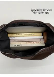 Vue de dessus du grand sac en cuir marron foncé montrant l'intérieur spacieux pour livres
