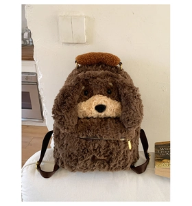 Detailed view of the brown plush puppy backpack with curly fleece and gold zipper closure