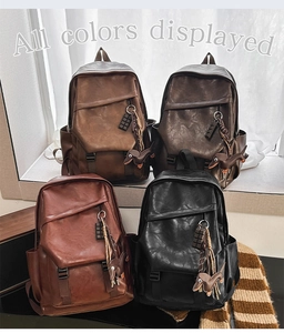 Multiple colors of vintage PU leather backpacks with unique charms on a window sill