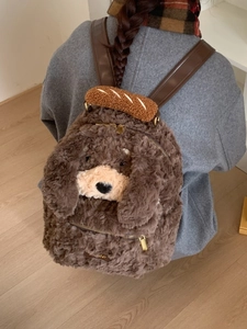 Cute brown plush puppy backpack with decorative baguette handle and leather straps