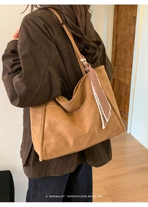 Brown retro tote bag detail with polka dot scarf accessory on a shoulder strap