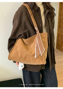 Retro brown oversized tote bag with silk scarf detail shown on woman's shoulder