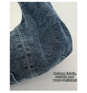Detail of durable dark blue denim fabric with reinforced double stitching and twill texture