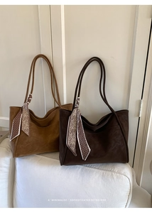 Detail of vintage tote bags in brown and coffee faux suede with silk scarf handles