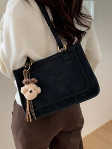 Minimalist black suede tote bag with woven handles and cute bear pendant for daily use