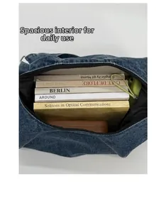 Detail view of the large capacity denim tote bag interior showing books and storage space