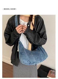 Lifestyle shot of large capacity blue denim shoulder bag on a model for retro casual look