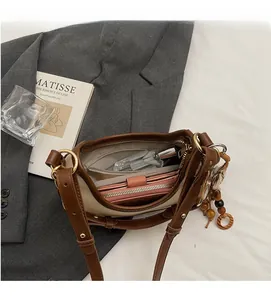 Top view of spacious interior with zipper pocket in a brown and white commuter bag