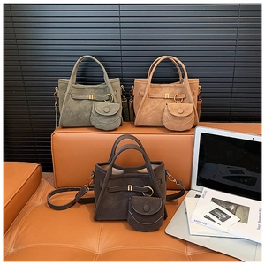 Close-up of suede bucket bags in olive, caramel and brown with mini pouch detail