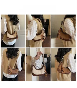 Detailed views of leather half-moon bag with gold chain strap and wooden bead tassel
