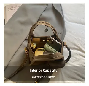 Top view of bucket bag showing interior space for smartphone, perfume and powder