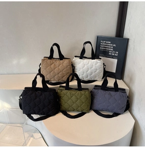 Detailed group view showing five colors of quilted tote bags with adjustable straps