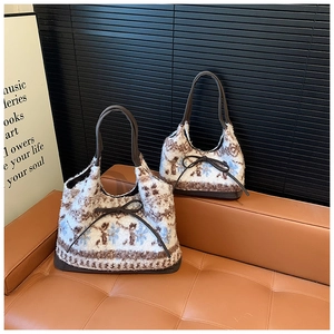 Close-up of plush tote bags with vintage snowflake patterns and brown bow details