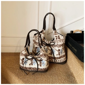 Detailed view of plush tote bags with seasonal snowflake patterns and leather handles