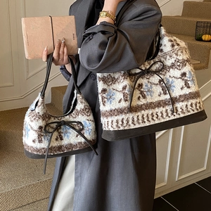 Detail of floral plush tote bags with leather straps and delicate bow accents