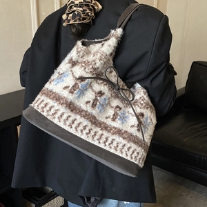 Detailed view of plush lamb-style tote bag with Nordic patterns and leather drawstring