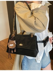 Vintage black tote bag with gold chain strap and plush leopard print charm accessory