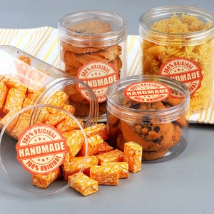 Set of four clear plastic storage jars with airtight lids and handmade labels