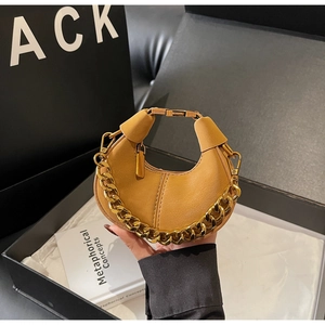 Detail of khaki leather mini bag with gold chain handle and premium metal hardware