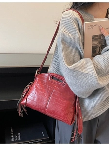 Dark red crocodile embossed leather tote bag with tassels and adjustable shoulder strap