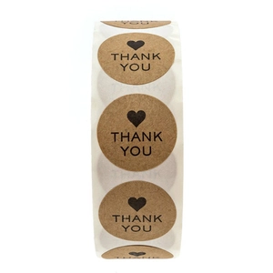 Roll of round brown kraft paper Thank You stickers with black heart for gift packaging