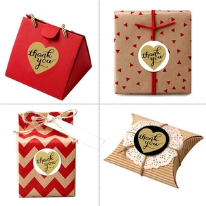 30mm Kraft heart-shaped Thank You stickers shown sealing gift boxes and paper bags