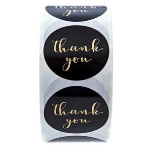 Roll of 1-inch black and gold foil thank you stickers for sealing and gift packaging