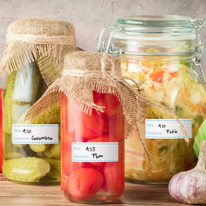Waterproof food storage labels on glass jars showing date and content fields