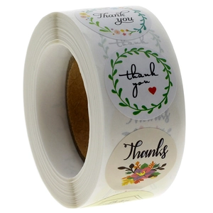 Roll of floral thank you stickers with botanical green leaf designs for wedding packaging