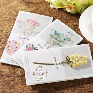 Handmade greeting cards with dried flowers and 'Especially for you' text on wood background