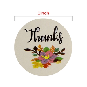 Floral Thank You roll stickers with black script and botanical designs, 1-inch diameter