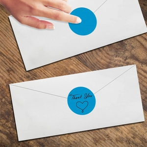 Detail of blue 'Thank You' stickers with heart motif for sealing gift envelopes