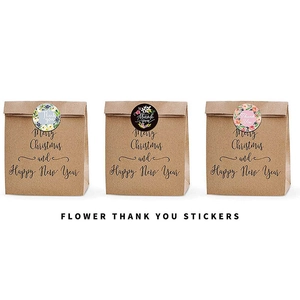 Three floral Thank You stickers on brown kraft gift bags for festive packaging detail