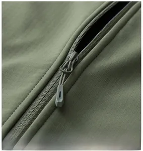 Detailed close-up of high-quality zipper and ripstop texture on army green outdoor vest