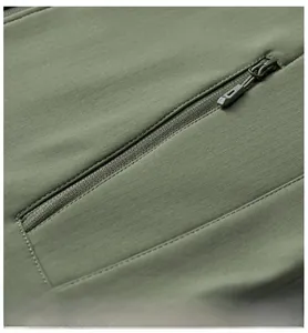 Detailed close-up of side zipper pocket on olive green outdoor tactical vest with ripstop fabric