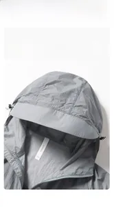 Detailed close-up of wide-brimmed grey UPF50+ sun protection jacket hood and collar