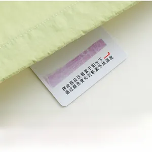 Détail de la carte de test UV sur le tissu vert clair de la veste de protection solaire