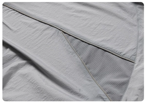 Detail view of breathable grey mesh fabric and reinforced stitching on sun protection jacket