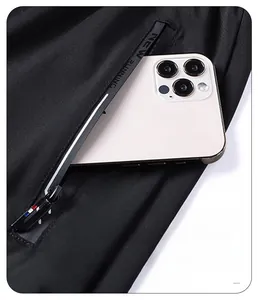 Dettaglio della tasca dei pantaloncini con cerniera e smartphone per mostrare lo spazio