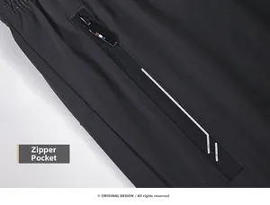 Close-up of running pants zipper pocket with text and moisture-wicking fabric