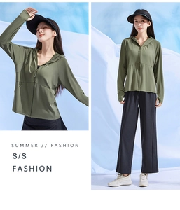 Close-up of olive green sun protection jacket and black wide-leg pants for summer