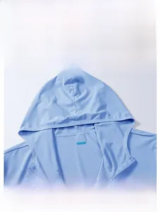 Detail view of breathable light blue sun protection hoodie featuring mesh texture and hood