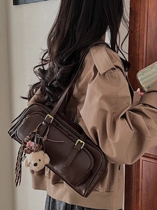 Retro dark brown faux leather shoulder bag with multiple zippers and plush dog charm