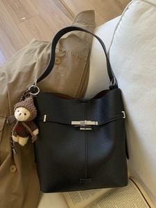 Classic black pebble leather bucket bag with silver clasp and cute bear pendant