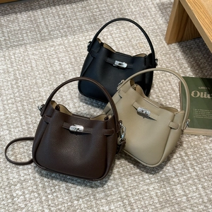 Detailed view of high-quality lychee grain leather bucket bags with metal turn-lock closures
