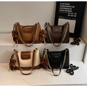 Close-up of color-block quilted chain bags in four colors with cute teddy bear charms