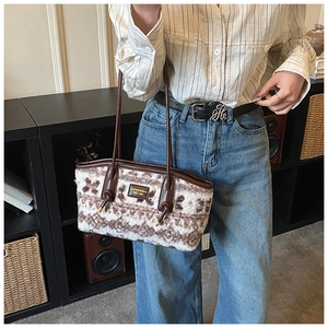 Close-up of vintage plush tote bag with brown pattern and logo leather patch detail