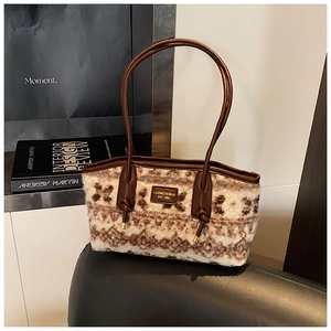 Close-up of retro floral plush tote with premium brown leather handles and branding