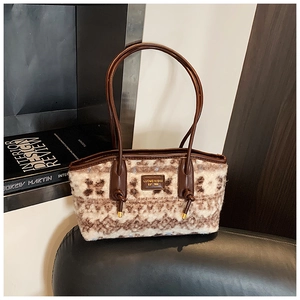 Detail of the warm beige and brown faux fur tote bag featuring premium leather handles